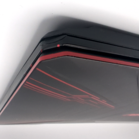 Sleek black and red gaming laptop with angular design details on the lid.
