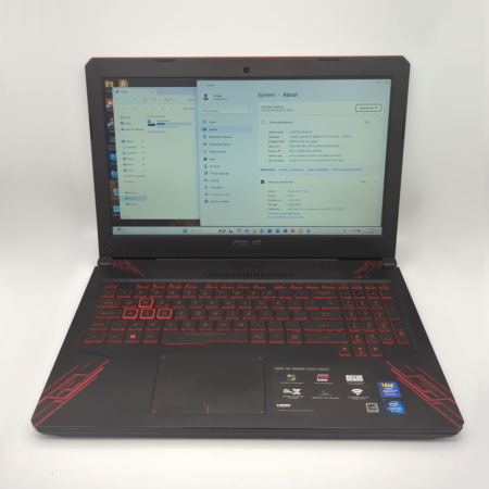 Gaming laptop displaying system specs on screen with illuminated red keyboard.