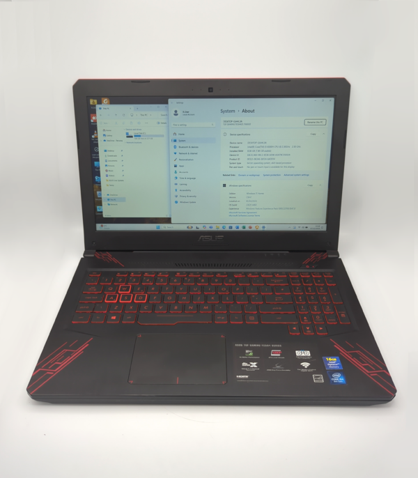 Gaming laptop displaying system specs on screen with illuminated red keyboard.