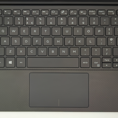 Laptop keyboard with trackpad, Windows 11, and Intel Core i7 sticker, viewed from above.
