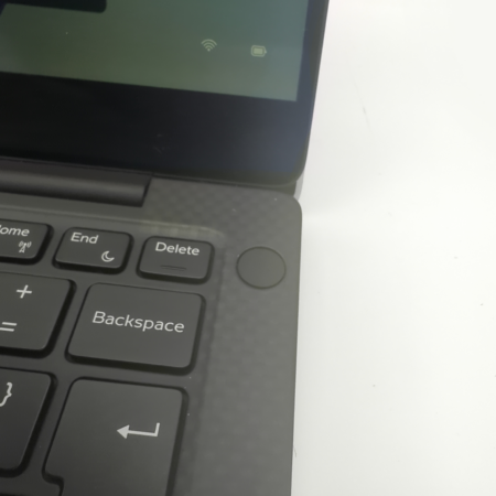 Close-up view of a laptop keyboard and screen corner, showcasing keys like Home, End, and Backspace.