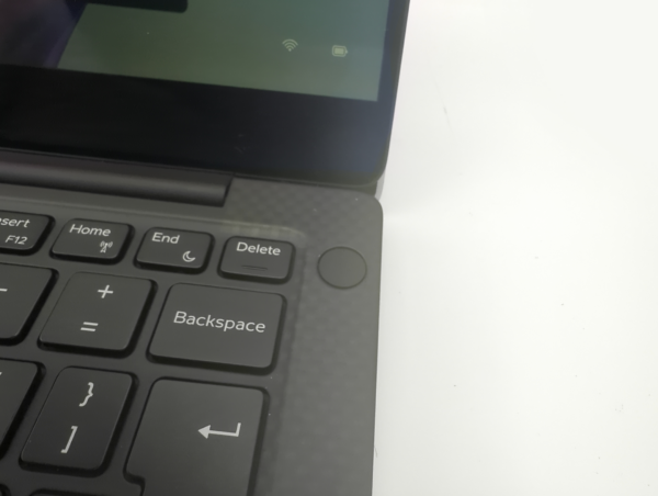 Close-up view of a laptop keyboard and screen corner, showcasing keys like Home, End, and Backspace.