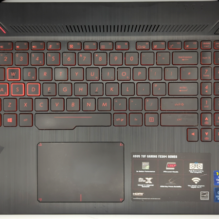 Asus TUF Gaming FX504 keyboard with red backlight and highlighted WASD keys, ideal for gaming enthusiasts.