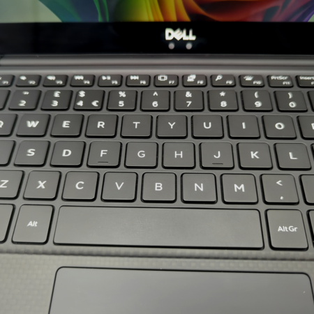 Close-up of Dell laptop keyboard with black keys and touchpad, showcasing QWERTY layout.