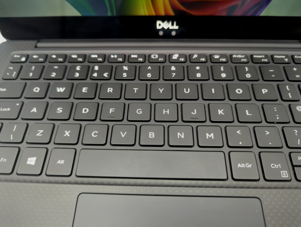 Close-up of Dell laptop keyboard with black keys and touchpad, showcasing QWERTY layout.