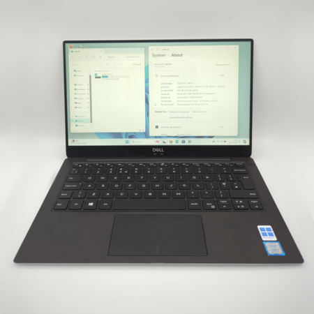Dell laptop displaying system info with Windows 11 interface, black keyboard.