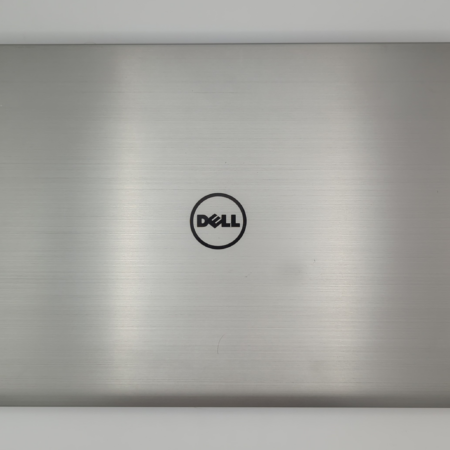 Silver Dell laptop closed on white background. Sleek minimalist design with Dell logo centered.