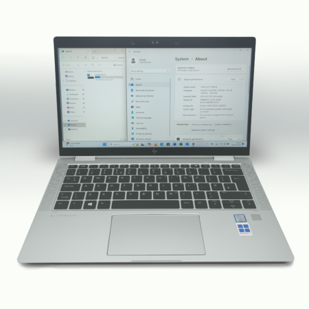 Silver laptop with Windows operating system displayed, showing system settings and device specifications.