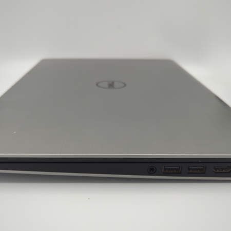 Side view of a sleek silver laptop with various ports visible, including USB, HDMI, and Ethernet.
