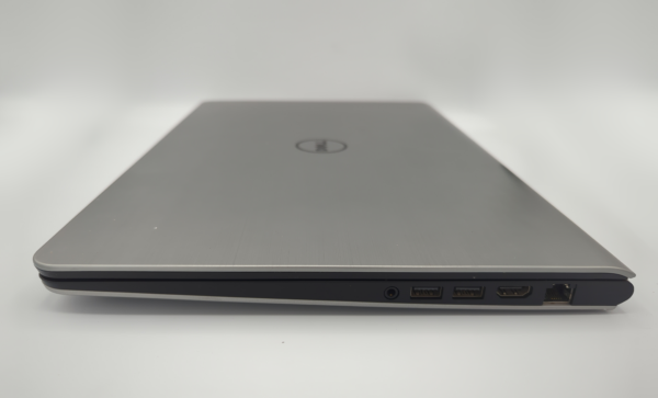 Side view of a sleek silver laptop with various ports visible, including USB, HDMI, and Ethernet.