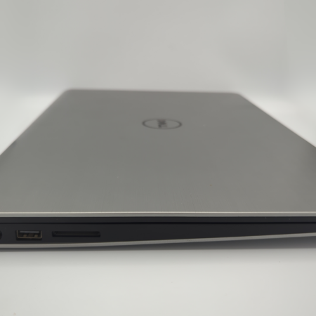Closed silver laptop with visible USB and charging ports on the side, against a white background.