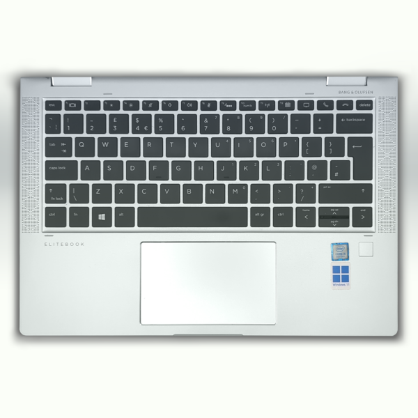 Silver laptop keyboard with touchpad, featuring Bang & Olufsen speakers and Intel Core i5, Windows 11 stickers.
