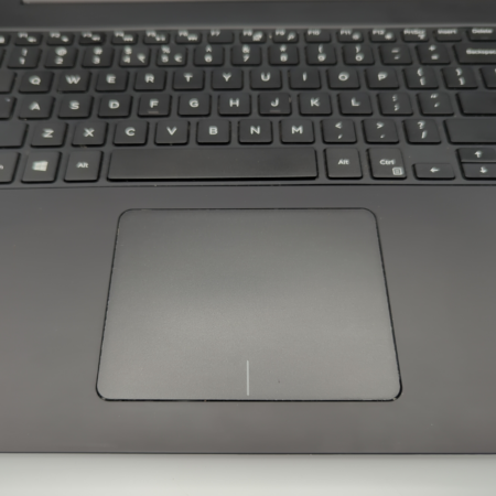 Close-up of a black laptop keyboard and touchpad, highlighting keys and smooth touchpad surface.