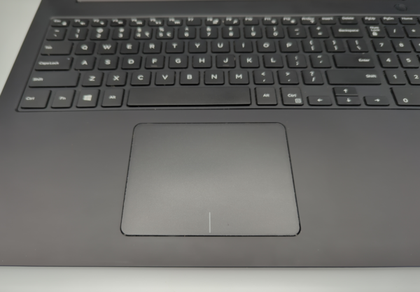 Close-up of a black laptop keyboard and touchpad, highlighting keys and smooth touchpad surface.