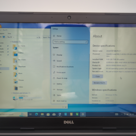 Laptop screen displaying Windows 10 device specifications and system settings.