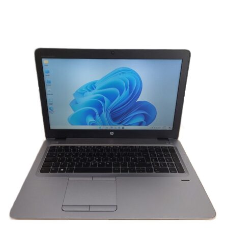 Laptop displaying a blue abstract design on the screen, featuring a black keyboard and trackpad.
