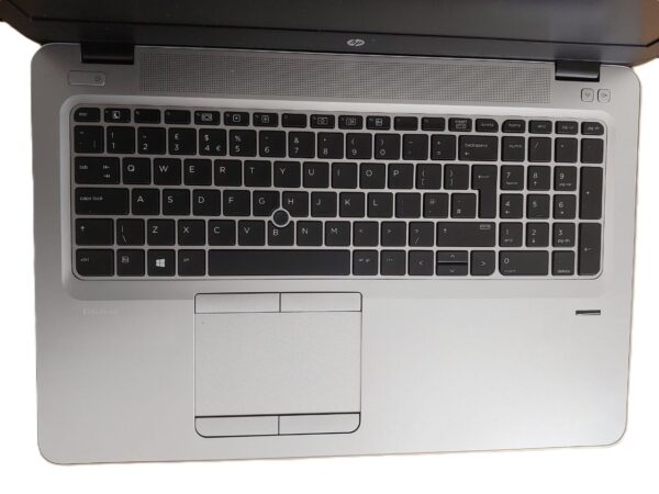 Top view of a laptop keyboard and touchpad on an HP EliteBook, featuring a sleek silver design and QWERTY layout.