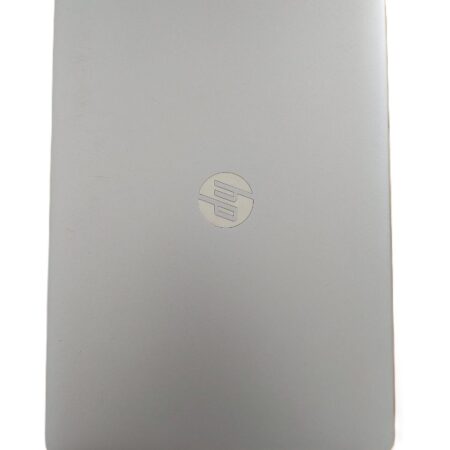 Silver laptop closed on white background, with brand logo visible on the top cover.