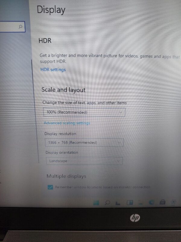 Adjusting display settings on a Windows computer, including HDR, scaling, and resolution options.