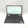 Open laptop displaying system specifications on the screen, showcasing its hardware and software details.