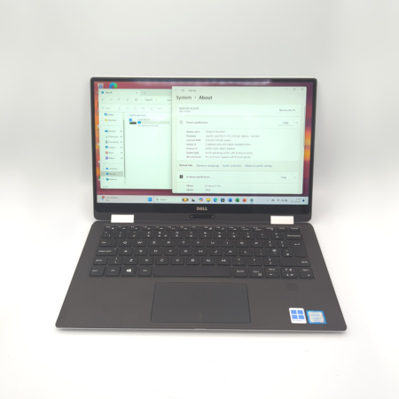 Open laptop displaying system specifications on the screen, showcasing its hardware and software details.