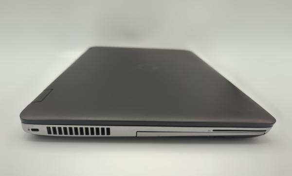 Closed black laptop on a white background, showing side detail with ports and vents.