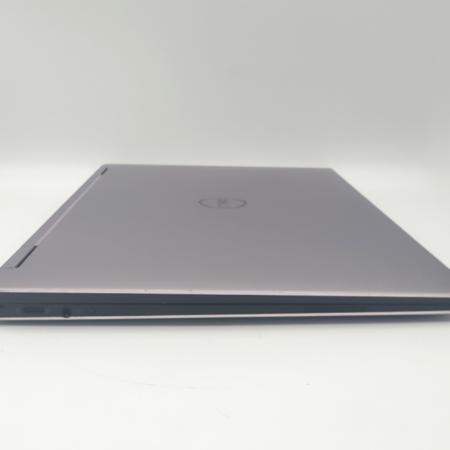 Slim silver laptop with closed lid, showcasing sleek design and modern style on a white background.