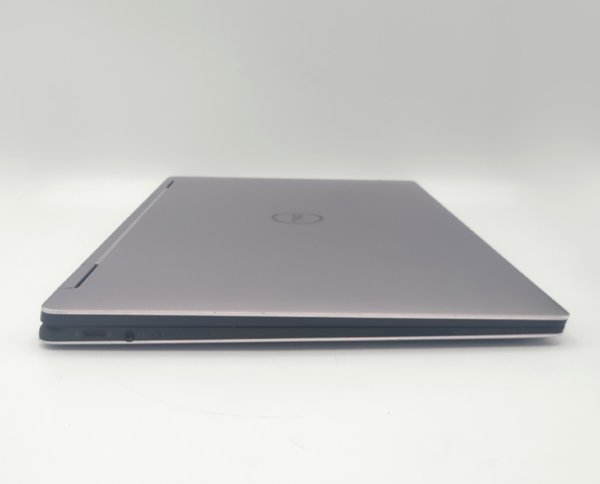 Slim silver laptop with closed lid, showcasing sleek design and modern style on a white background.