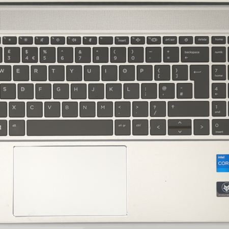 Silver laptop keyboard with Intel Core i5 and Windows 11 stickers, showing a numeric keypad and touchpad.
