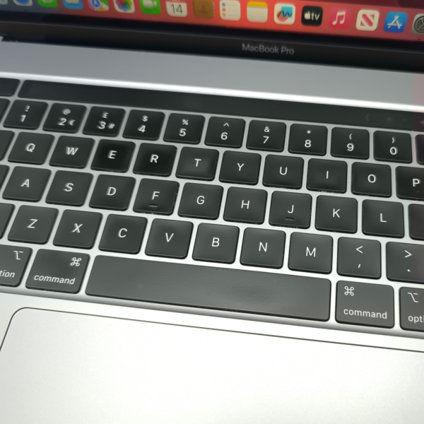 Close-up of a MacBook Pro keyboard with visible keys and touchpad, highlighting sleek design and functionality.