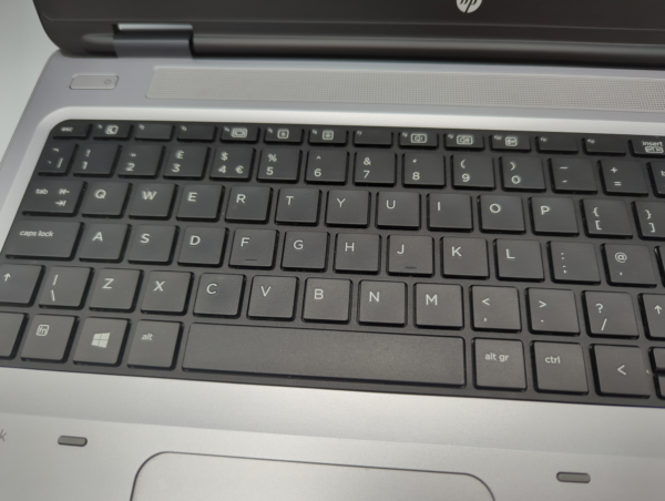 Laptop keyboard close-up showing black keys with white lettering.