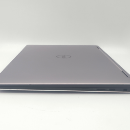 Closed silver laptop on a white background, showcasing its sleek and thin design.