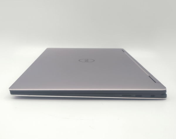 Closed silver laptop on a white background, showcasing its sleek and thin design.
