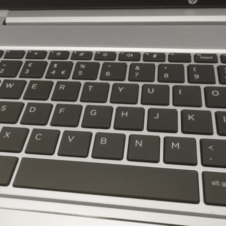 Close-up of a QWERTY laptop keyboard layout showing keys and symbols.