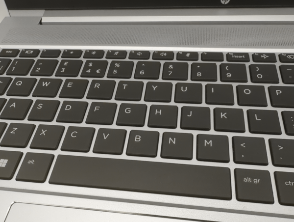 Close-up of a QWERTY laptop keyboard layout showing keys and symbols.
