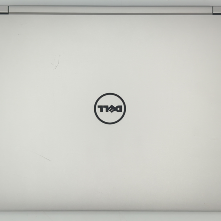 Closed silver laptop with Dell logo on lid, viewed from above.