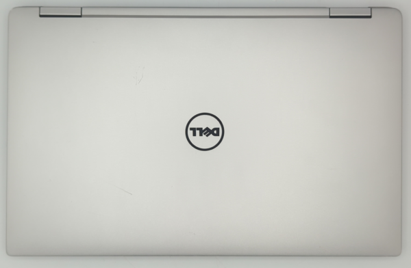 Closed silver laptop with Dell logo on lid, viewed from above.