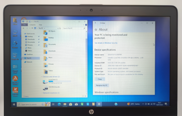 Laptop screen displaying Windows 10 PC specifications with Intel i5 processor and 8GB RAM.