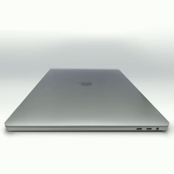Closed silver laptop on white background, showcasing a sleek design with visible ports on the side.