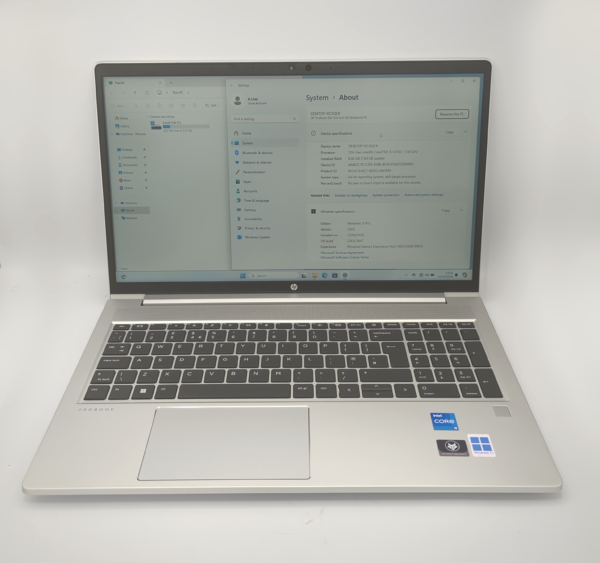 Silver laptop with Windows 11 displayed, featuring a keyboard.