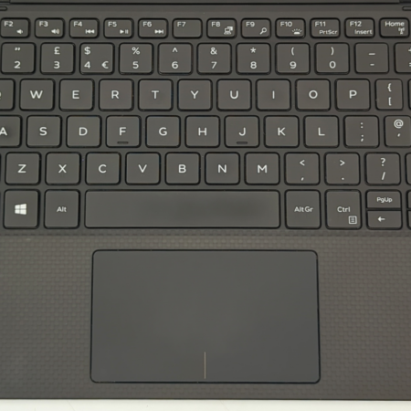 Black laptop keyboard and touchpad with Windows 11 and Intel Core i7 stickers on the palm rest.