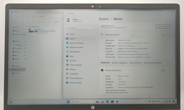 Laptop screen displaying system specifications and Windows 11 details on the settings panel.