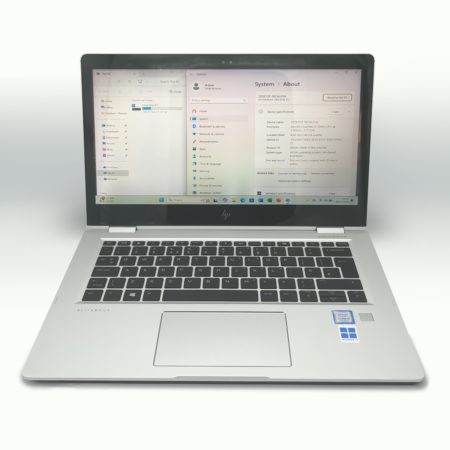 Silver HP laptop with an open screen displaying Windows system settings.