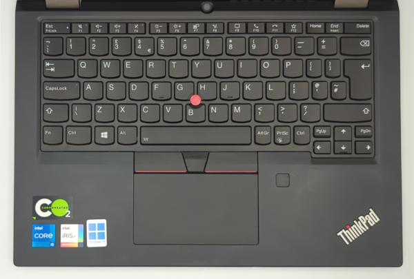 ThinkPad laptop keyboard, touchpad, and Intel Core i5 sticker, showcasing ergonomic design and branding.