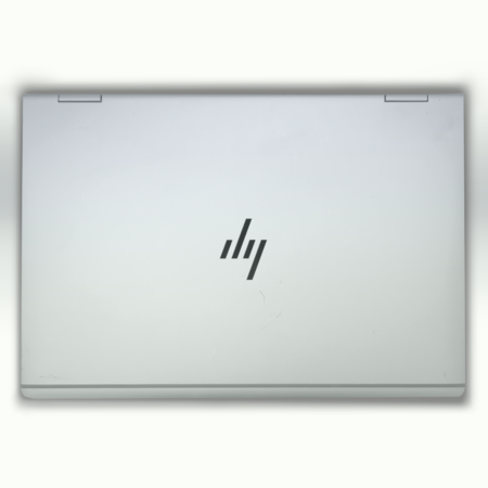 Silver laptop closed on a white background, showcasing a sleek and minimalist design with a logo on the top cover.