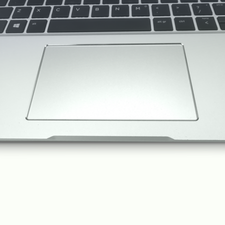 Close-up of a silver laptop touchpad and keyboard, highlighting the sleek design and modern functionality.