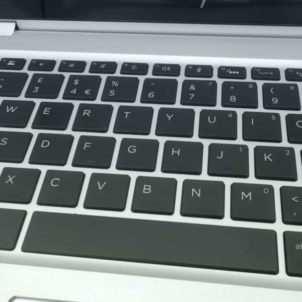 Close-up of a laptop keyboard showing black keys on a silver frame for efficient typing and productivity.