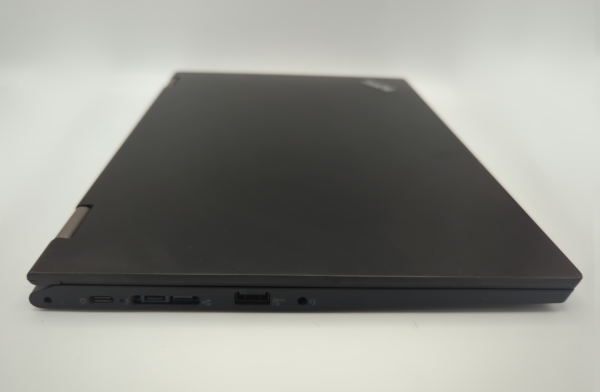 Closed black laptop with visible USB ports on a white background.