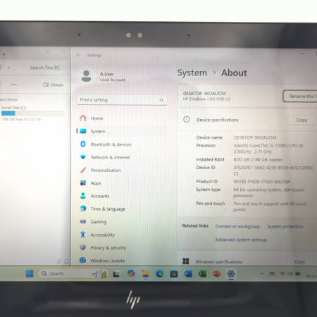 Laptop screen displaying Windows System About page with device specifications.