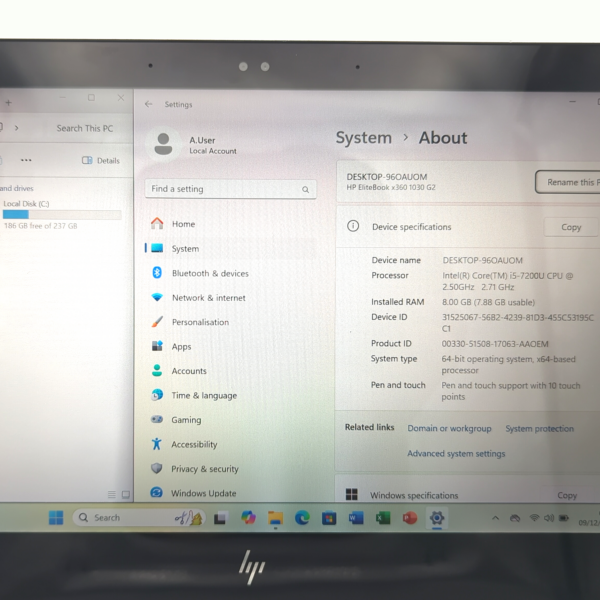 Laptop screen displaying Windows System About page with device specifications.